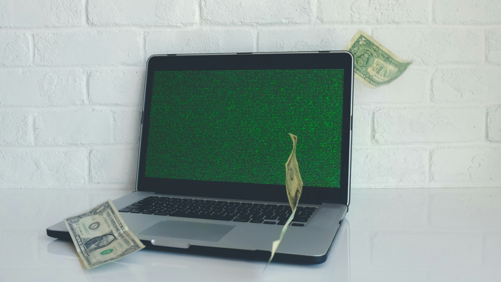 Money flowing from laptop screen