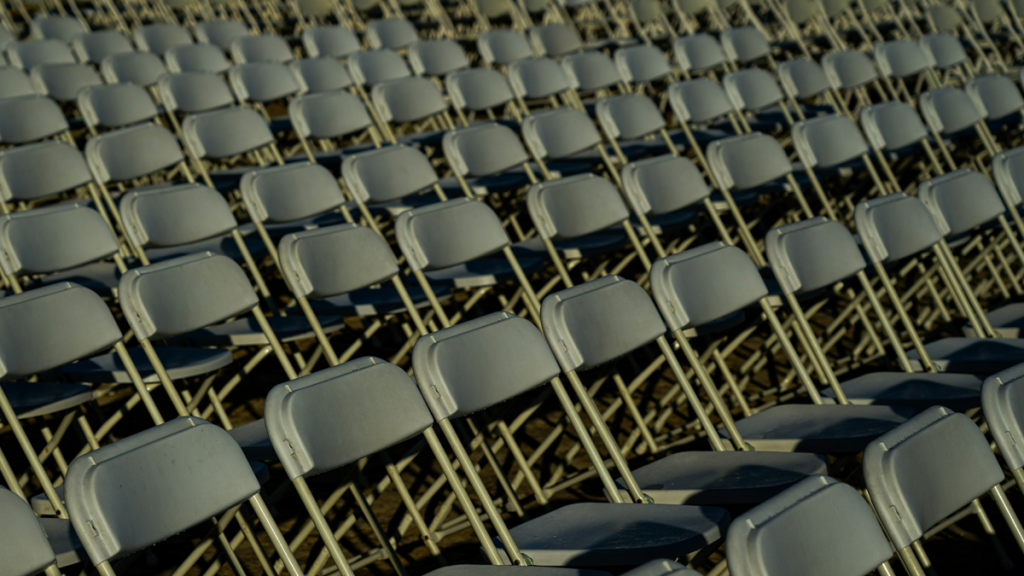 Empty folding chairs in outdoor venue