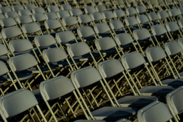 Green folding chairs arranged in rows