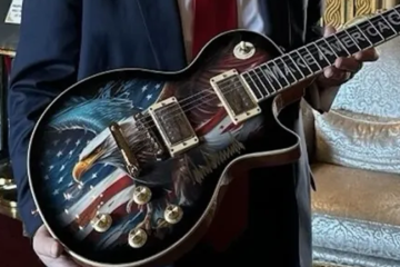 Man with Trump-themed Gibson guitar