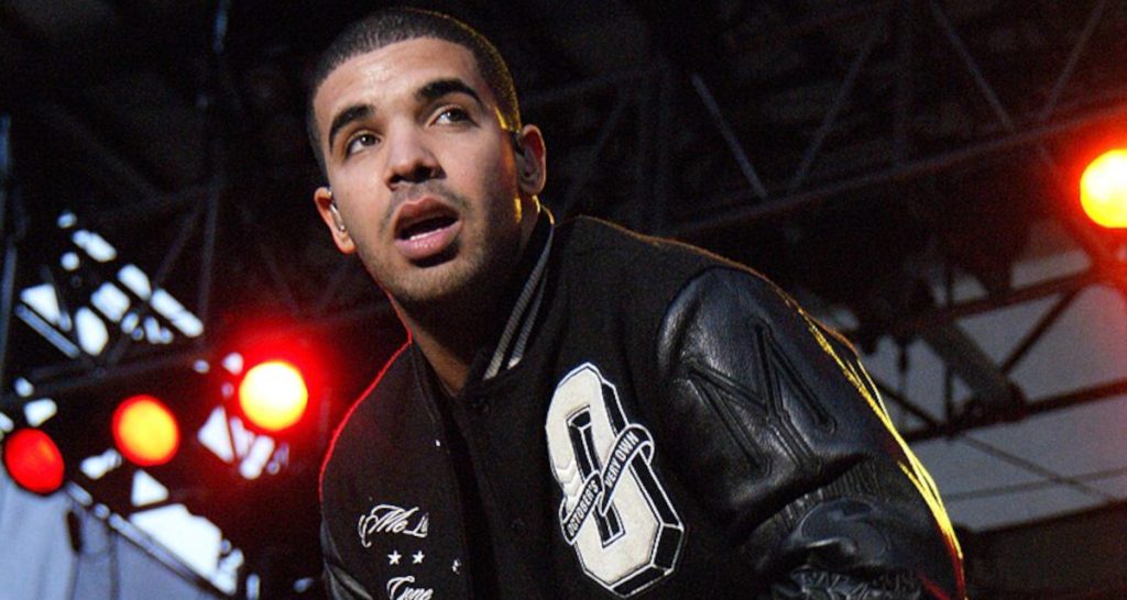 Drake wearing black jacket on stage