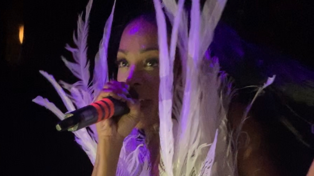 Cassandra Davis performing with microphone