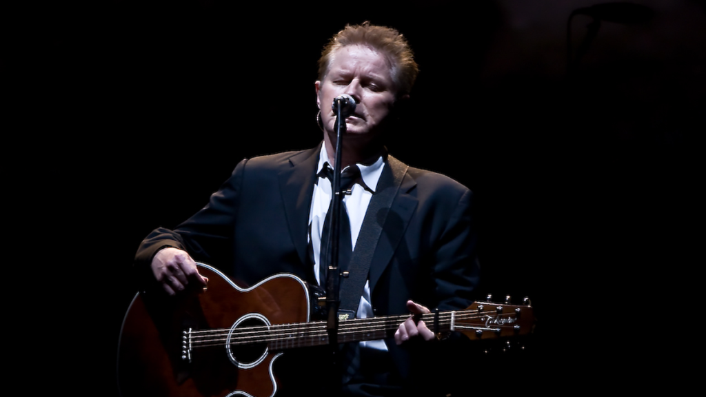 Don Henley performing with acoustic guitar