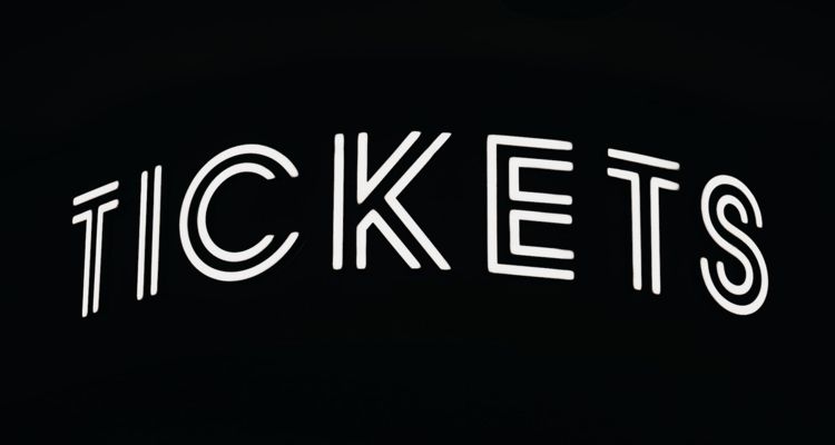 White tickets text on dark background