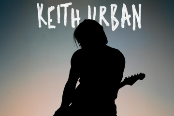 Keith Urban performing with guitar silhouette