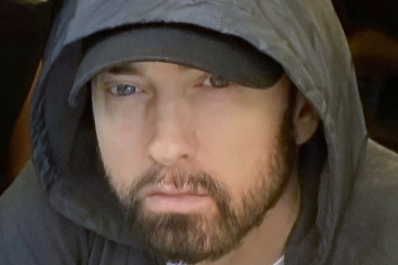 Eminem wearing gray hoodie, close-up