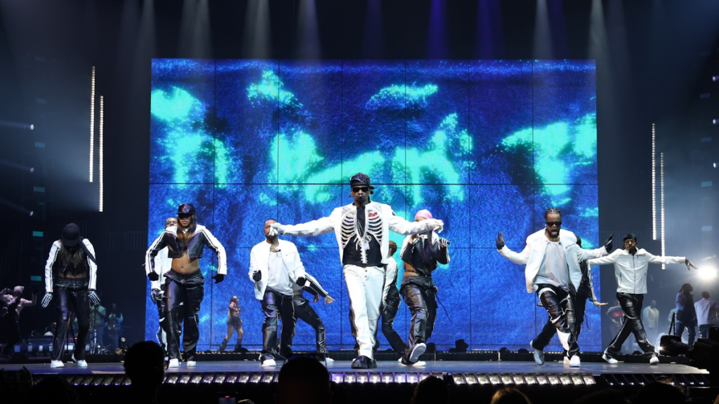 Usher on stage during concert tour