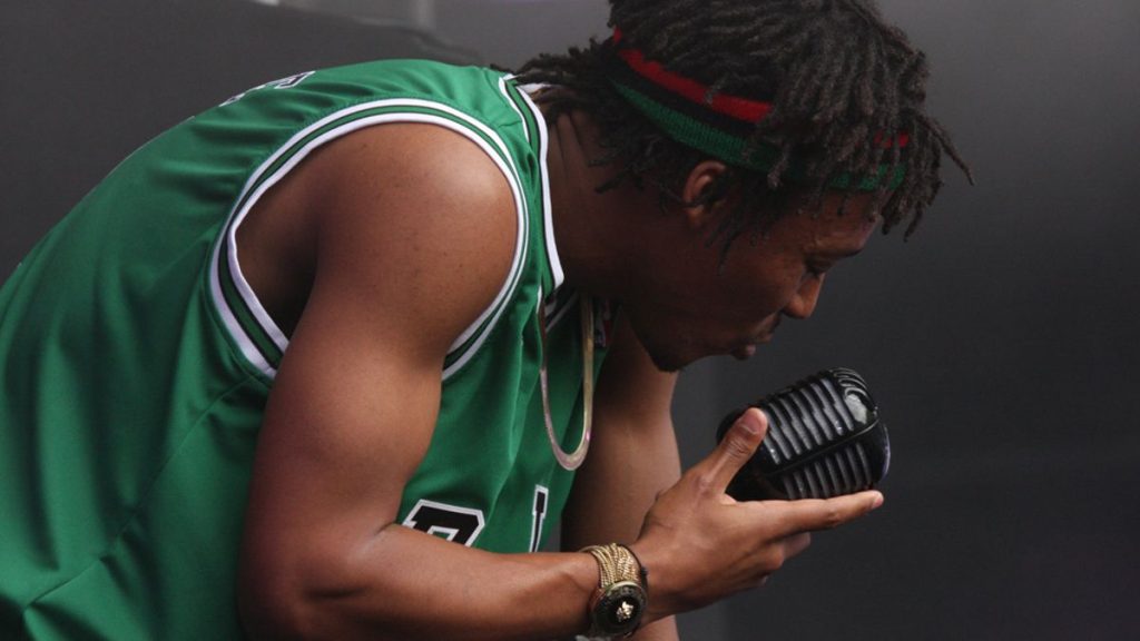 Lupe Fiasco speaking with microphone