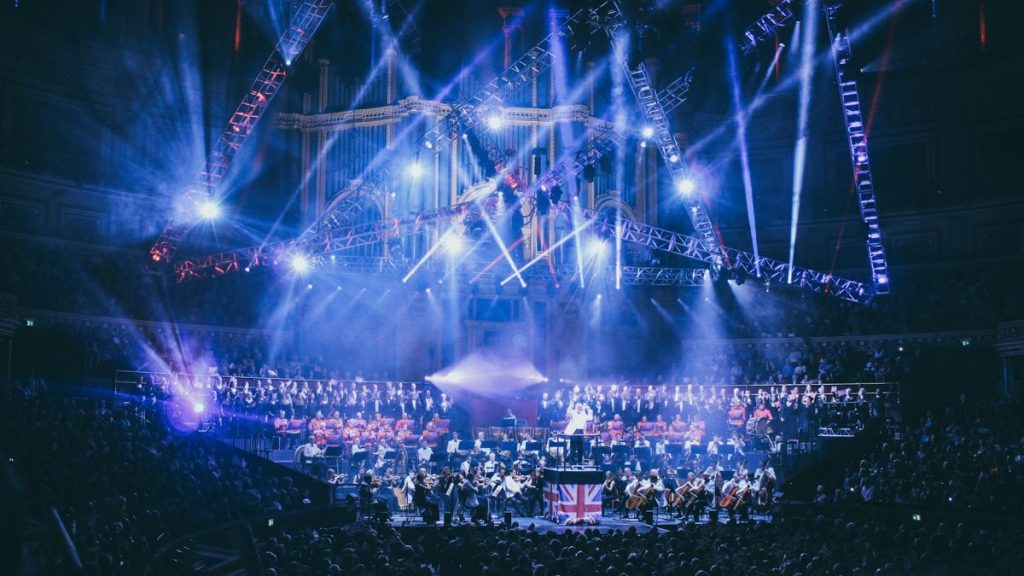 Concert orchestra performing with choir onstage