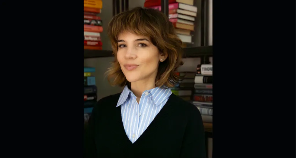 Katie Welle with bookshelf backdrop